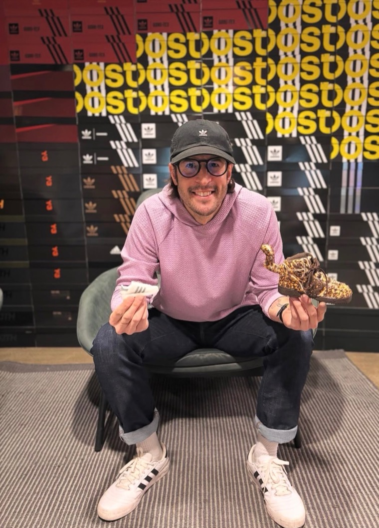 Brice Posin at adidas headquarters holding sneakers